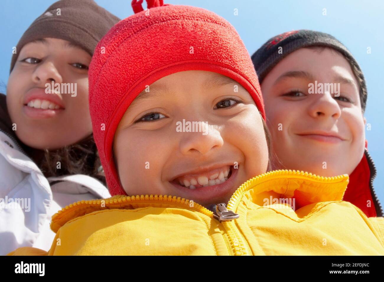 Porträt eines Jungen, der mit seinen beiden Freunden lächelt Stockfoto