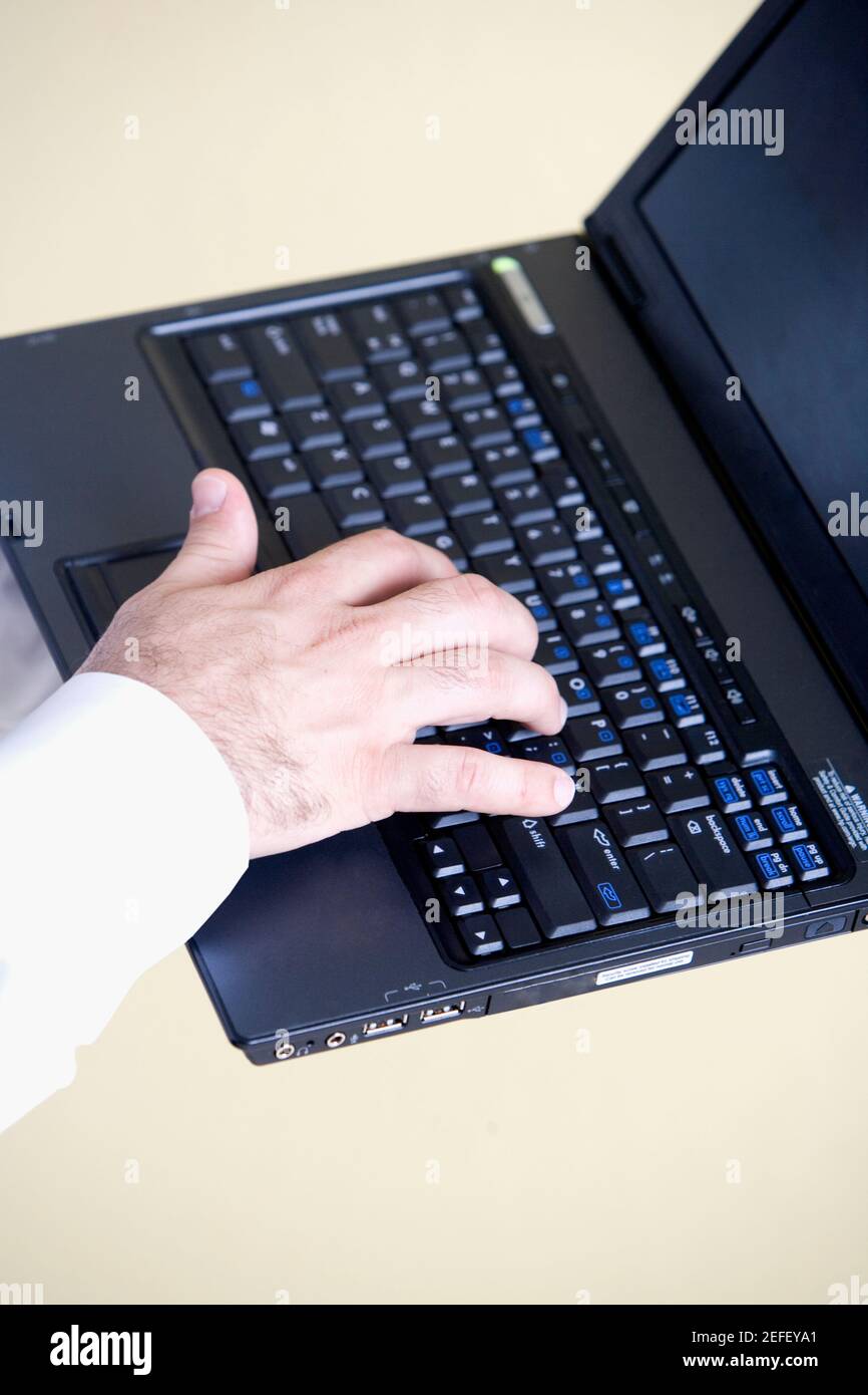 Nahaufnahme einer personÅ½s Hand mit einem Laptop Stockfoto