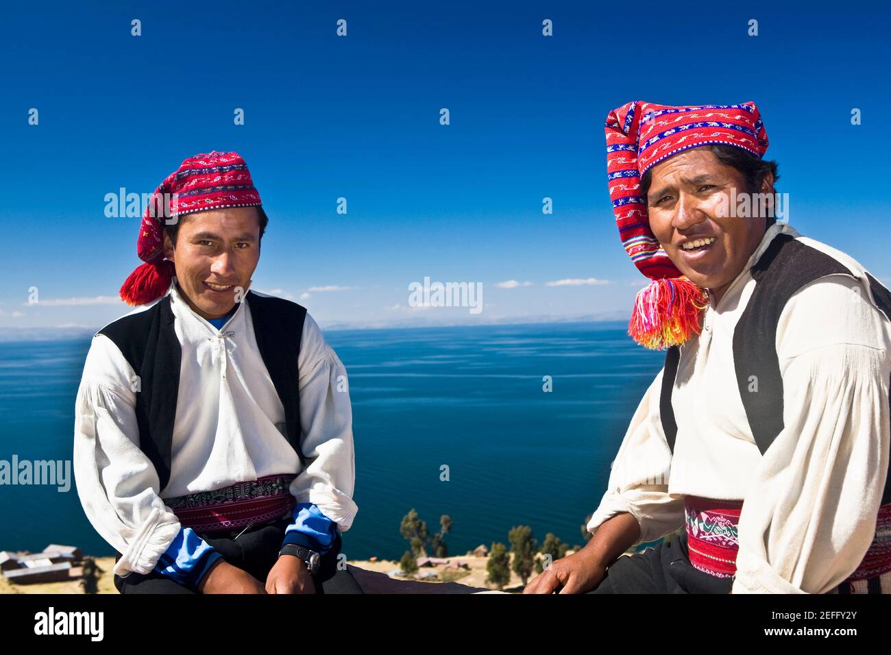 Porträt zweier junger Männer, die sitzen, Taquile Island, Titicacasee, Puno, Peru Stockfoto
