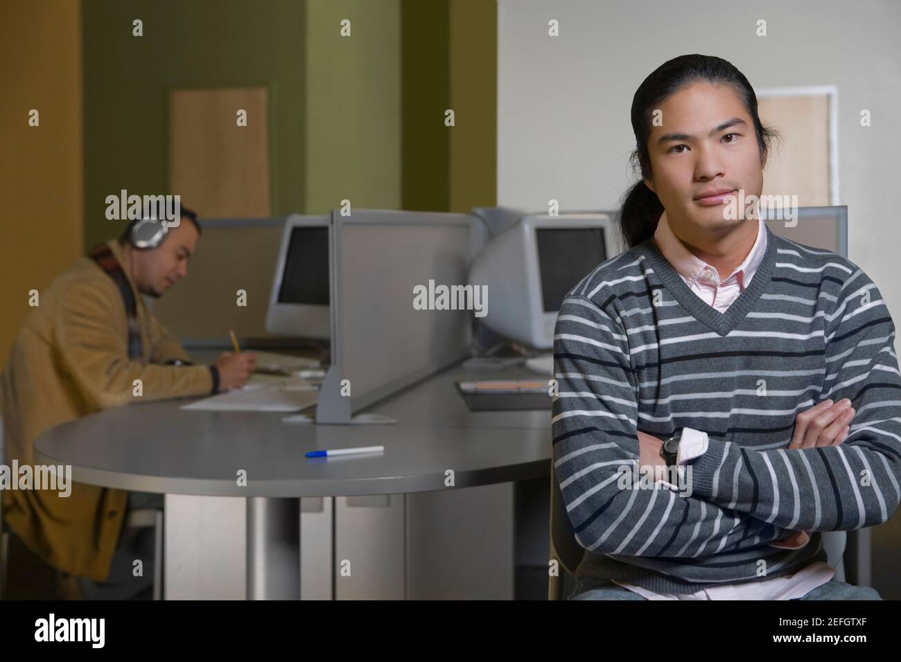 Porträt eines jungen Mannes mit seinen Armen gekreuzt Stockfoto