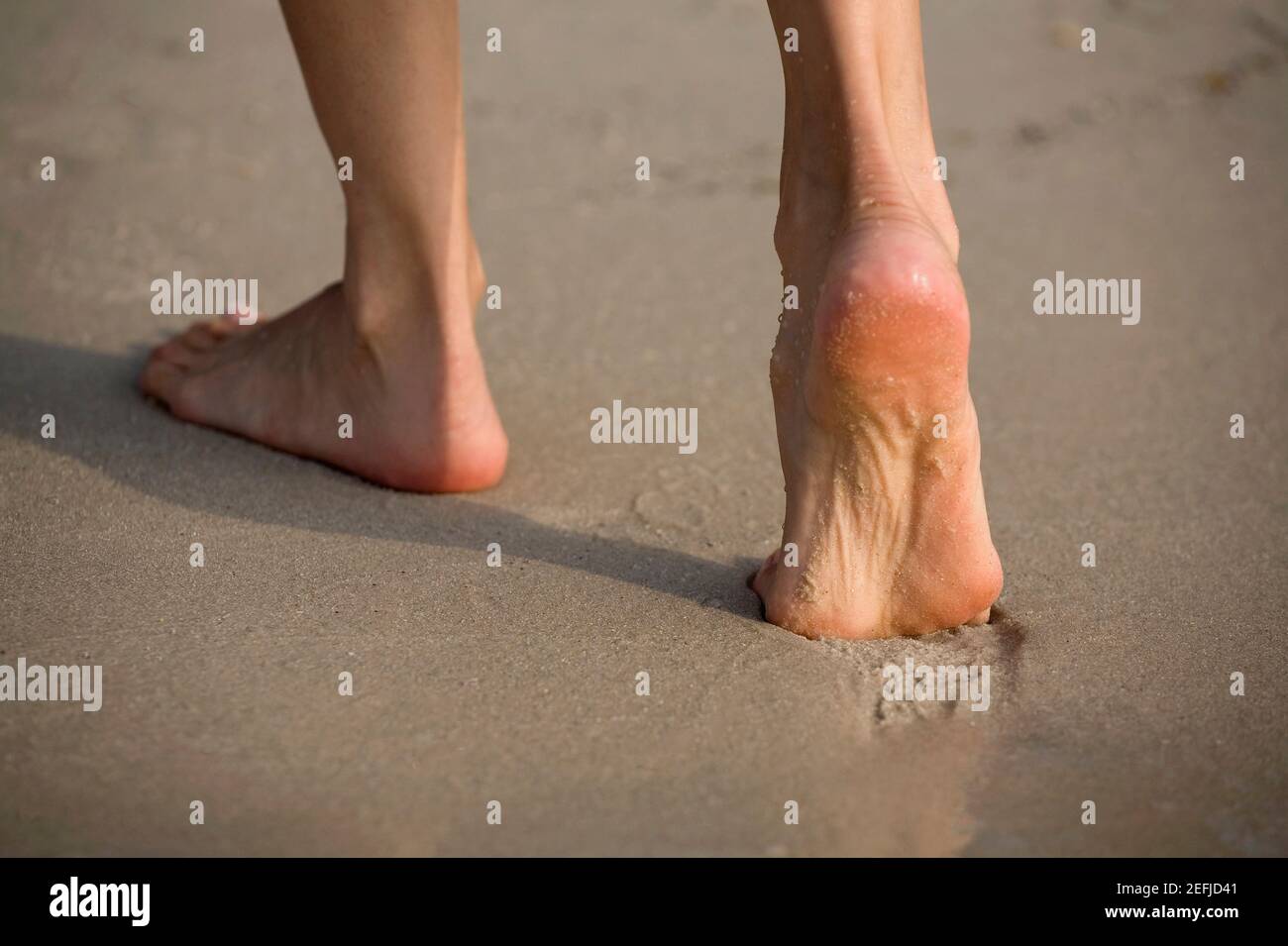 Tiefer Blick auf eine Person, die am Strand läuft Stockfoto