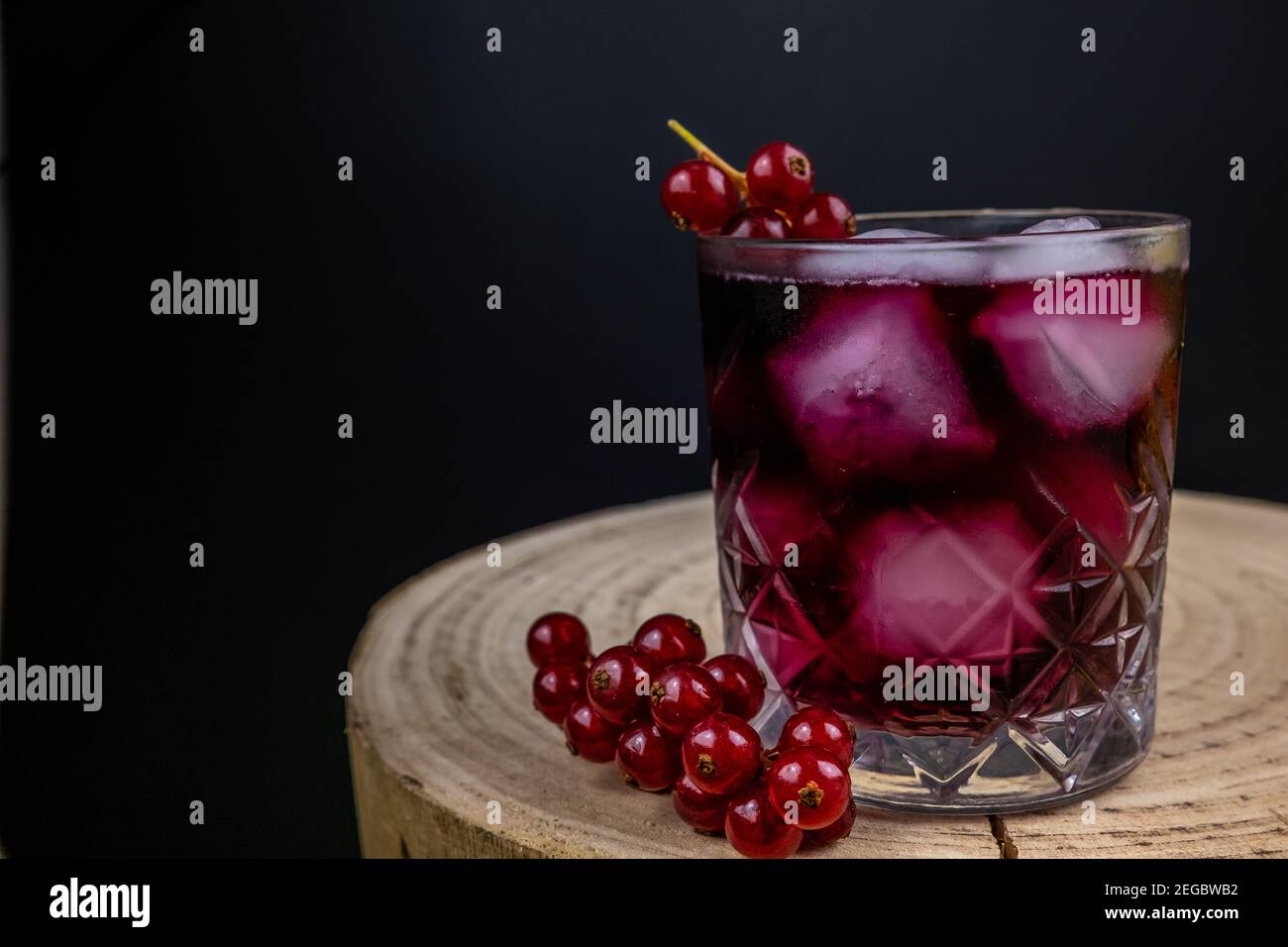 Glas Johannisbeere Wasser dunklen Hintergrund, Holztisch Stockfoto