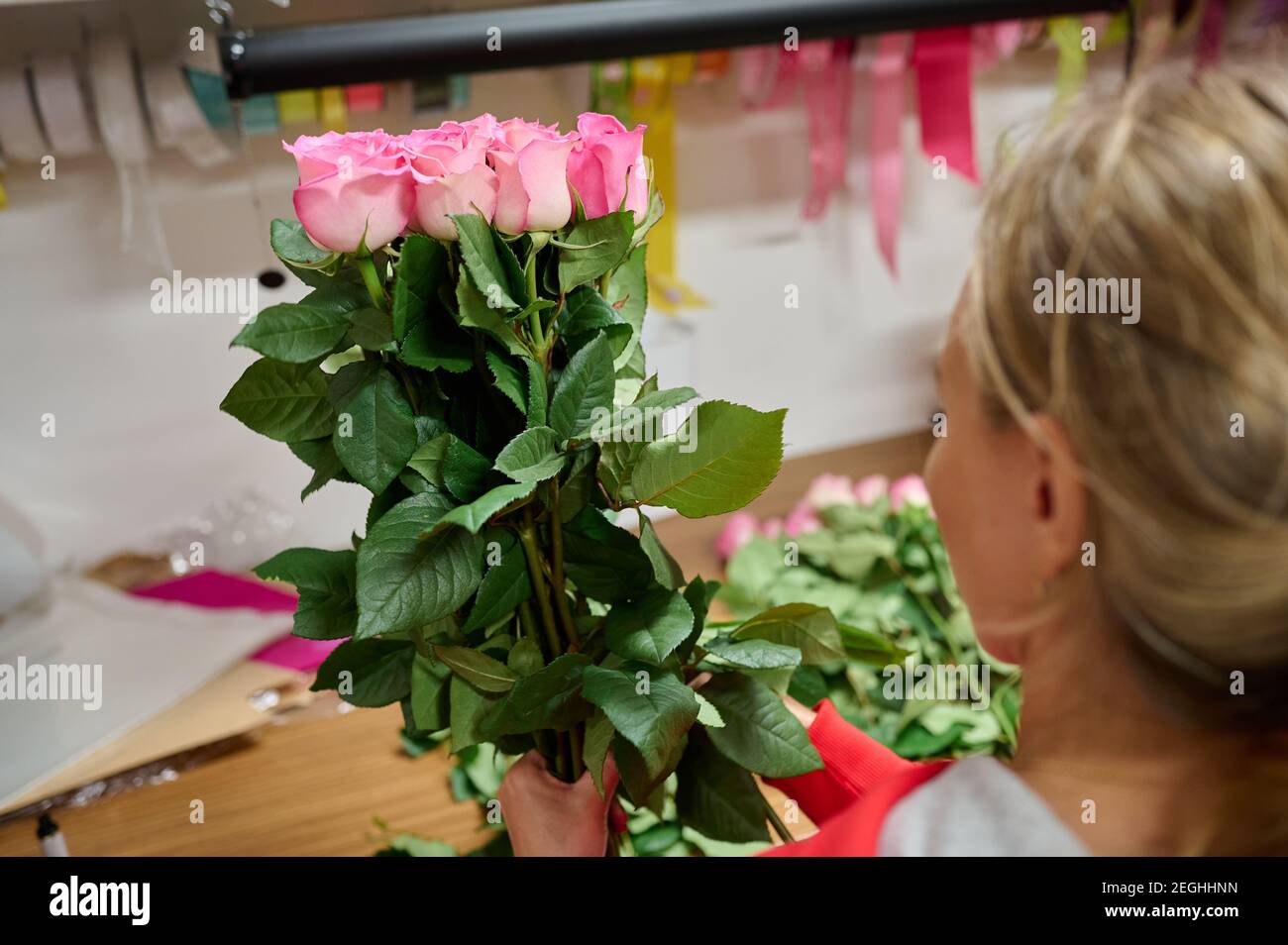 Blumenhändler, der Strauß mit rosa Rosen macht Stockfoto