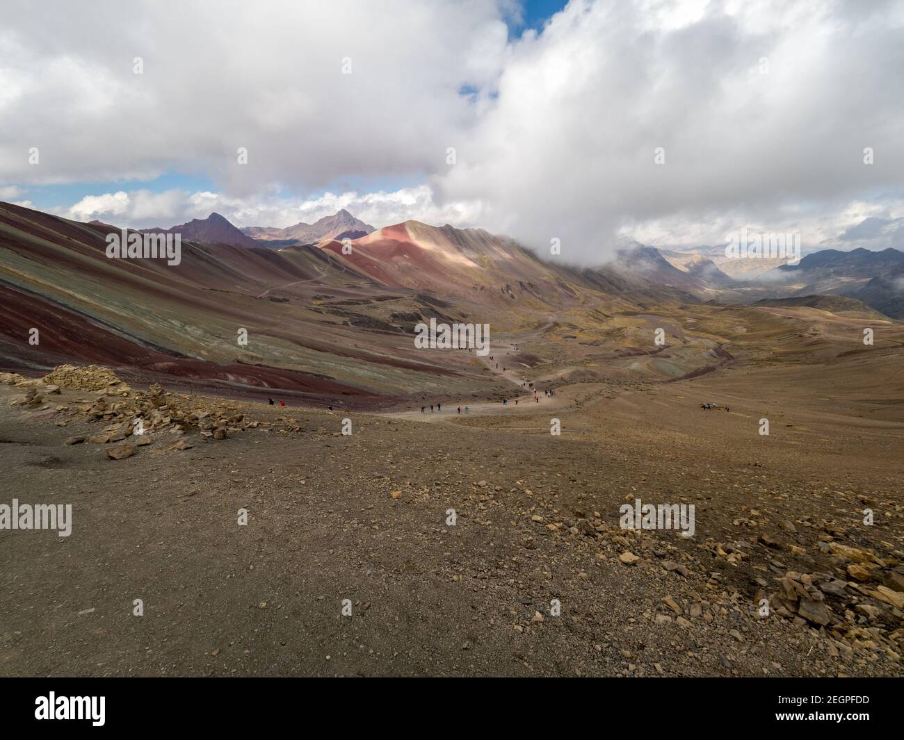 Dramatische Landschaft von Vinicunca auch als der Regenbogen Berg bekannt, auf der Ferne Touristen zu Fuß den Weg Stockfoto