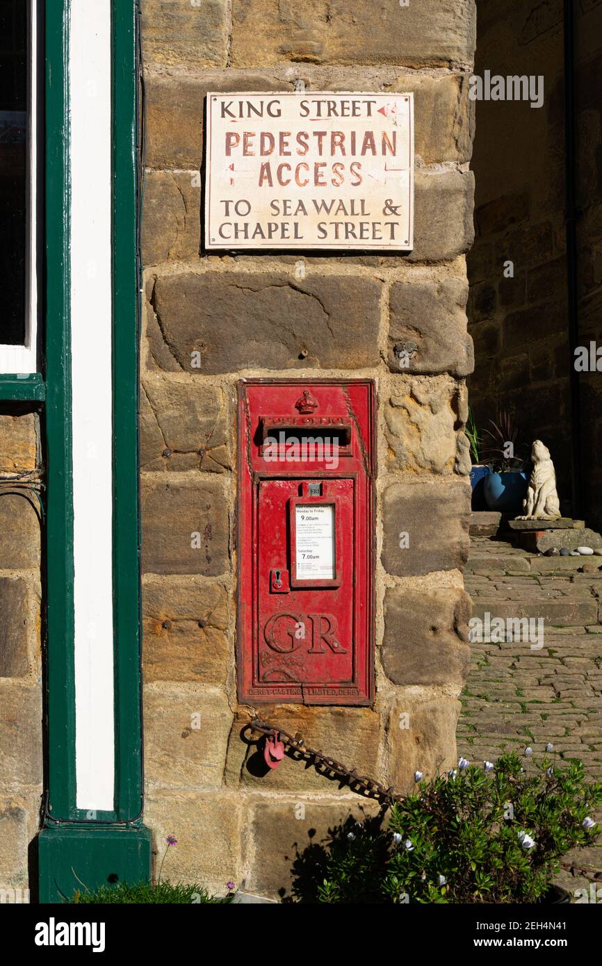 Ein altmodischer Briefkasten mit den Buchstaben GR, Robin Hood's Bay, Yorkshire, England Stockfoto