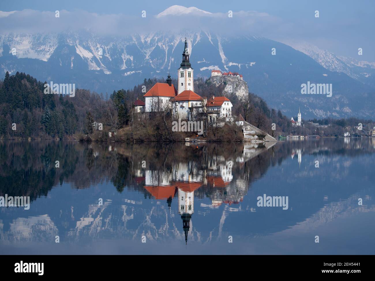 Bled, Slowenien. Februar 2021, 19th. Die Kirche Mariä Himmelfahrt auf der Insel Blejski Otok im Bleder See am Fuße der Pokljuka-Hochebene. Im Hintergrund ist die Burg Bled zu sehen. Die Biathlon-Weltmeisterschaft findet vom 10-21. Bis 22. Februar in Pokljuka statt. Quelle: Sven Hoppe/dpa/Alamy Live News Stockfoto