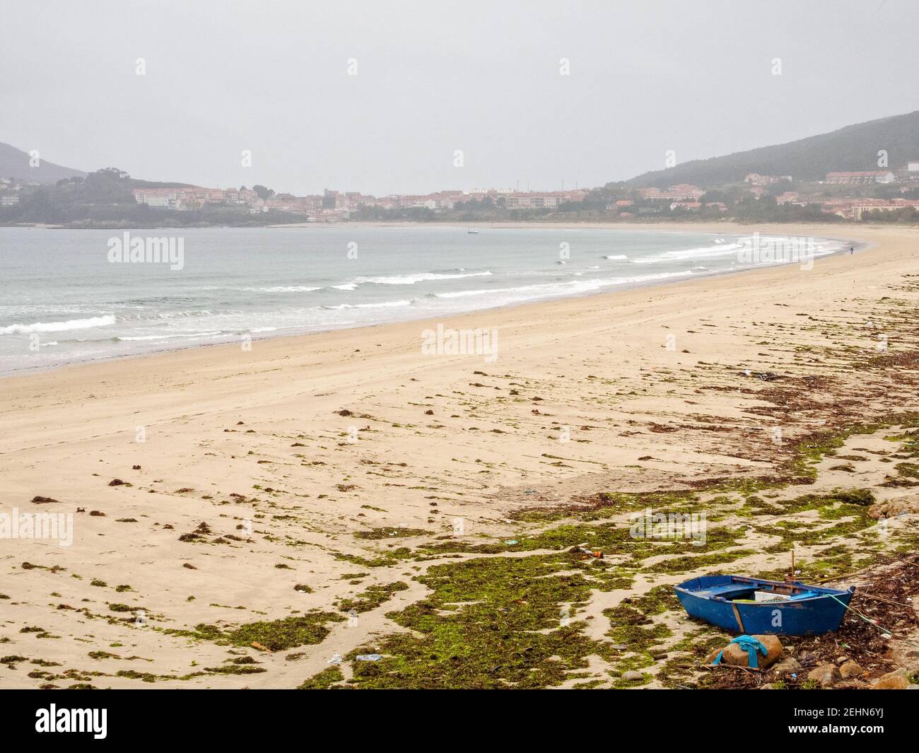 Blaues Boot an der Küste bei Ebbe gebunden - Praia de Langosteira, Galicien, Spanien Stockfoto