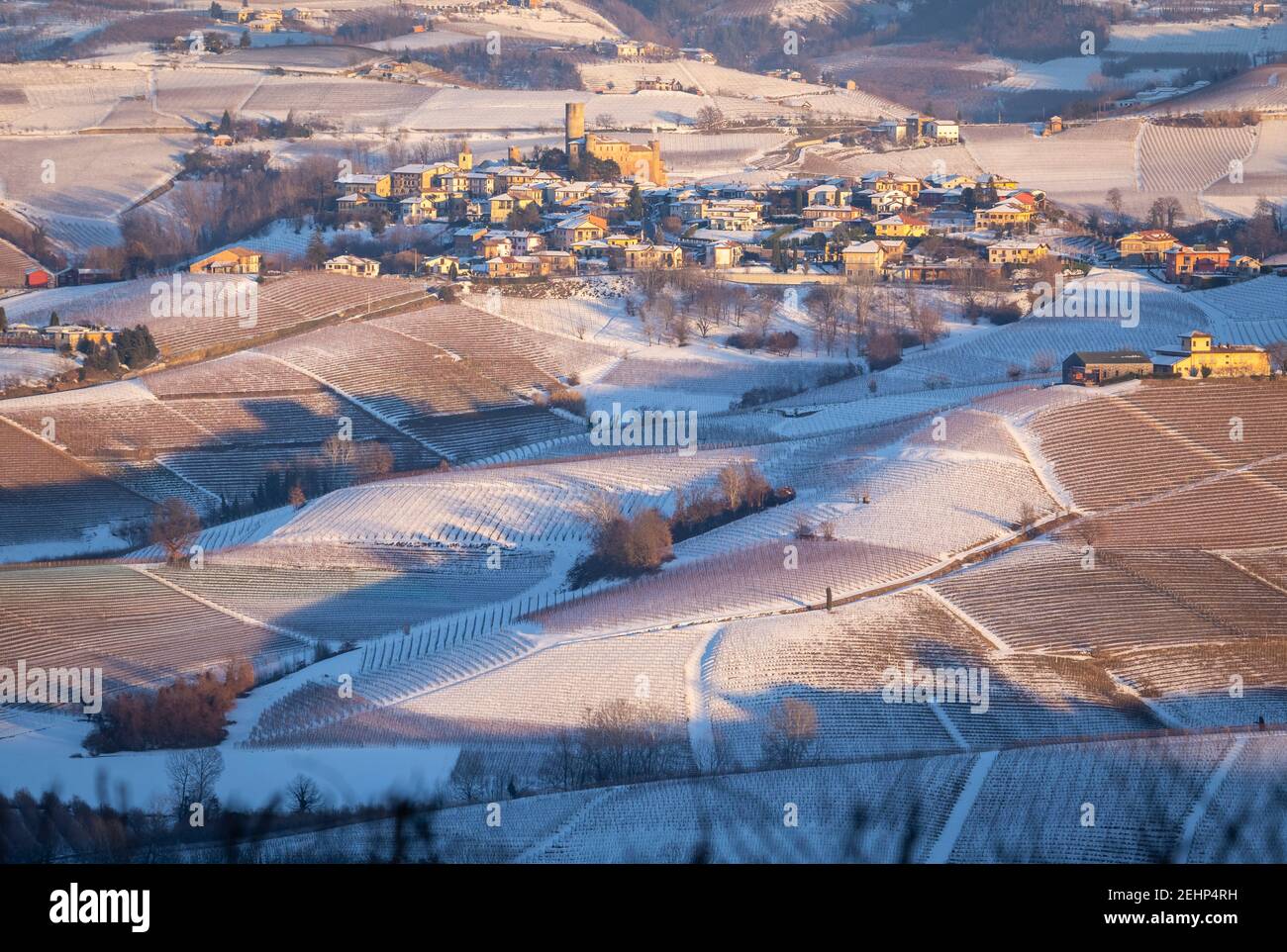 Blick auf die Stadt und das Schloss von Castiglione Falletto von La Morra bei Sonnenuntergang im Winter. Langhe, Bezirk Cuneo, Piemont, Italien. Stockfoto