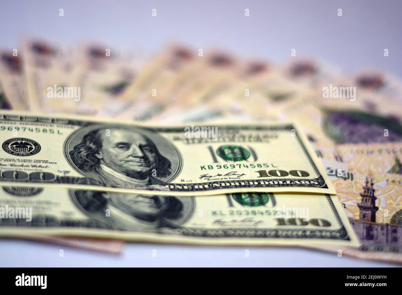 Selektiver Fokus der ägyptischen Landeswährung mit US-Dollar-Banknoten. Verschwommenes Geld. Ägyptisches Geld und amerikanische Dollar Wechselkurs,. Stockfoto