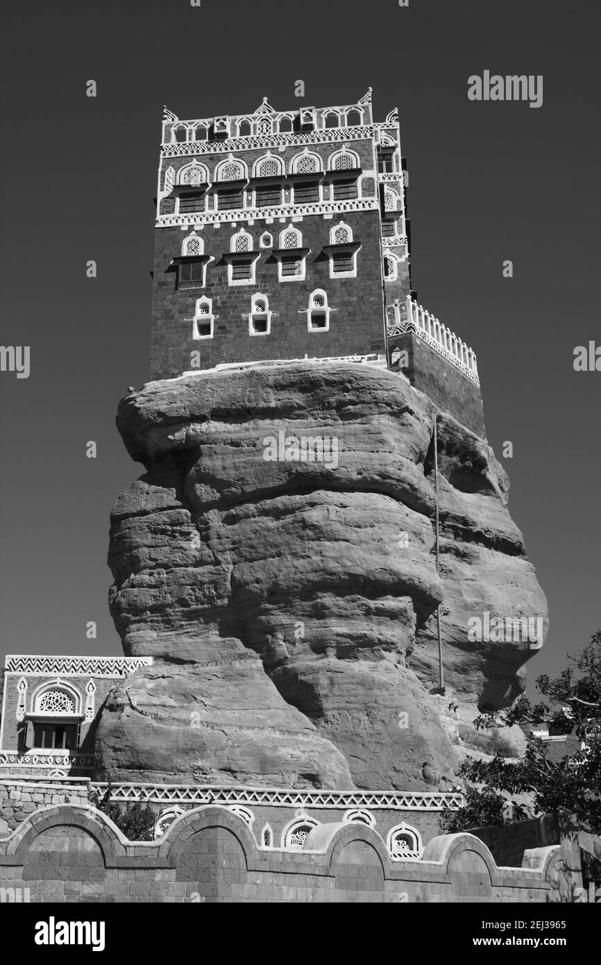 Monochromes, schwarz-weißes Bild des dar al Hajar Felspalastes im Wadi Dhahr, in der Nähe von Sana’a, Jemen Stockfoto