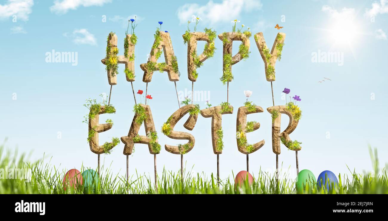 Bunte Happy Easter Schriftzug auf grünem Gras Stockfoto