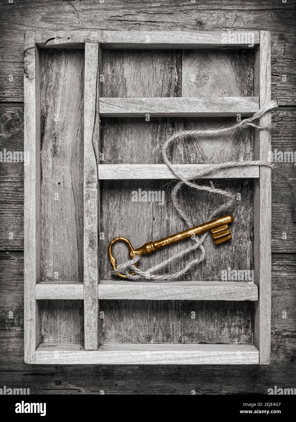 Vintage goldener Schlüssel mit Schnur im Fach der Holzkiste, Draufsicht Stockfoto