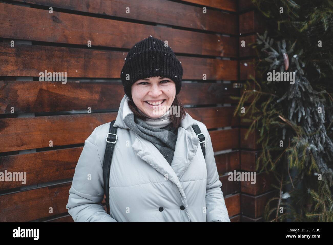 Porträt einer lächelnden Frau am verschneiten Wintertag Stockfoto