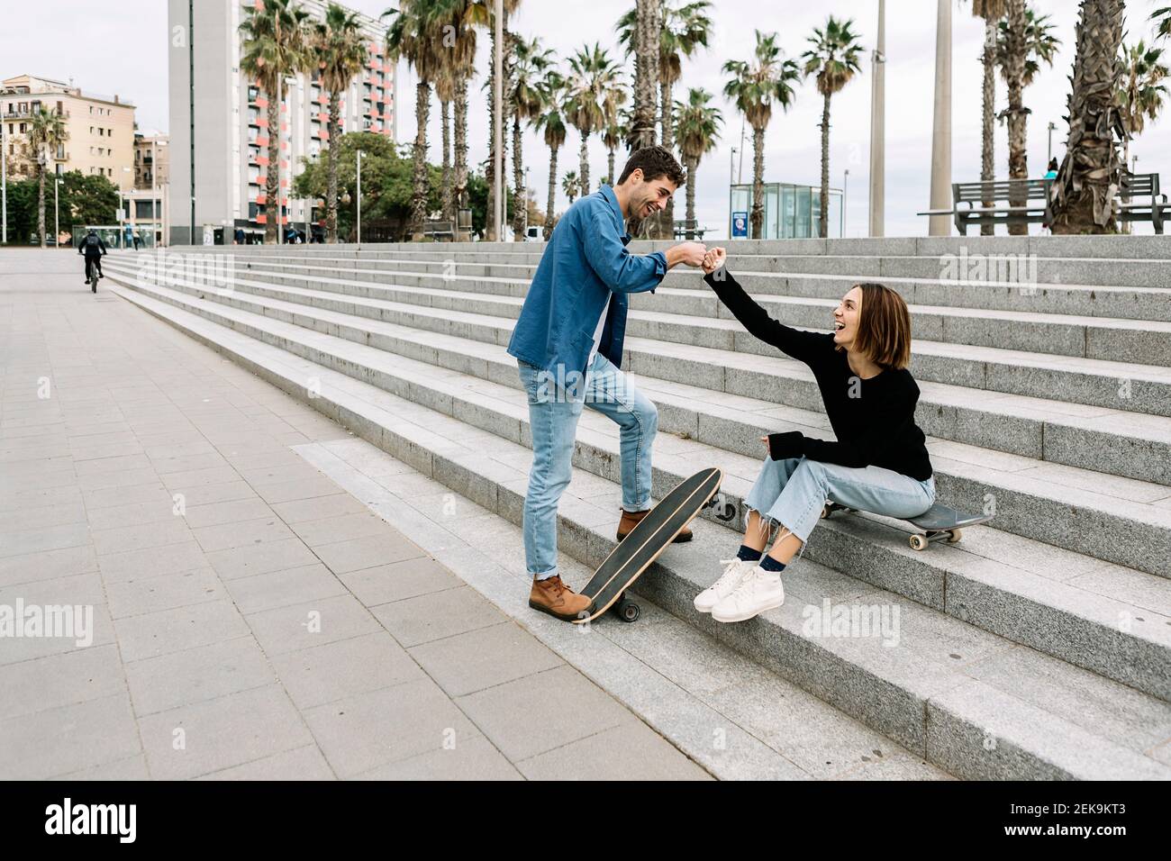 Paar mit Skateboards Faust stoßen im Freien Stockfoto
