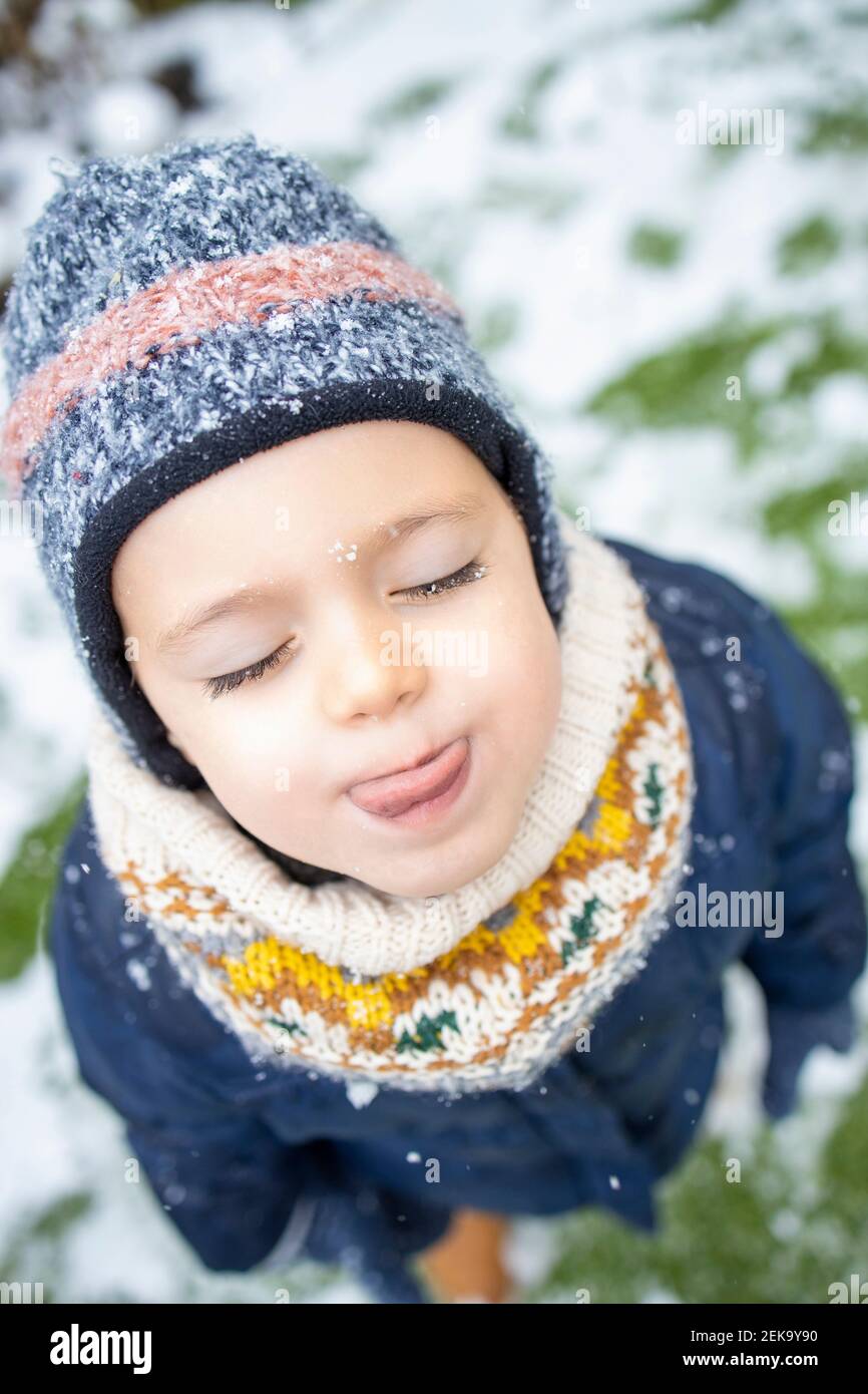 Mädchen Kind in warmer Kleidung während Schneefall Stockfoto