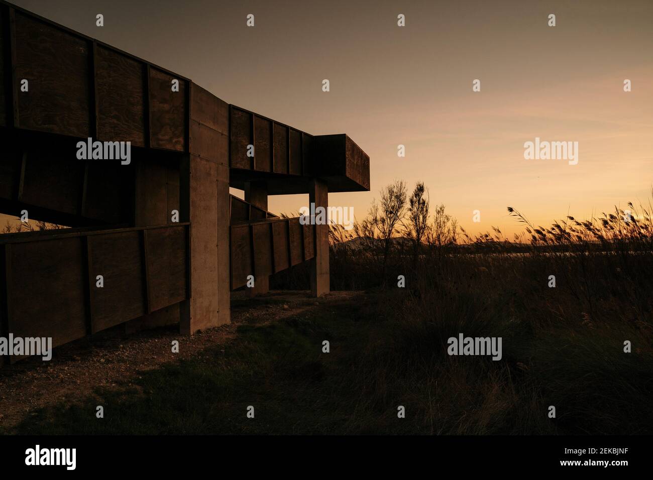 Spanien, Ebro Delta, Sonnenuntergang über Landschaft mit Architekturelement Stockfoto