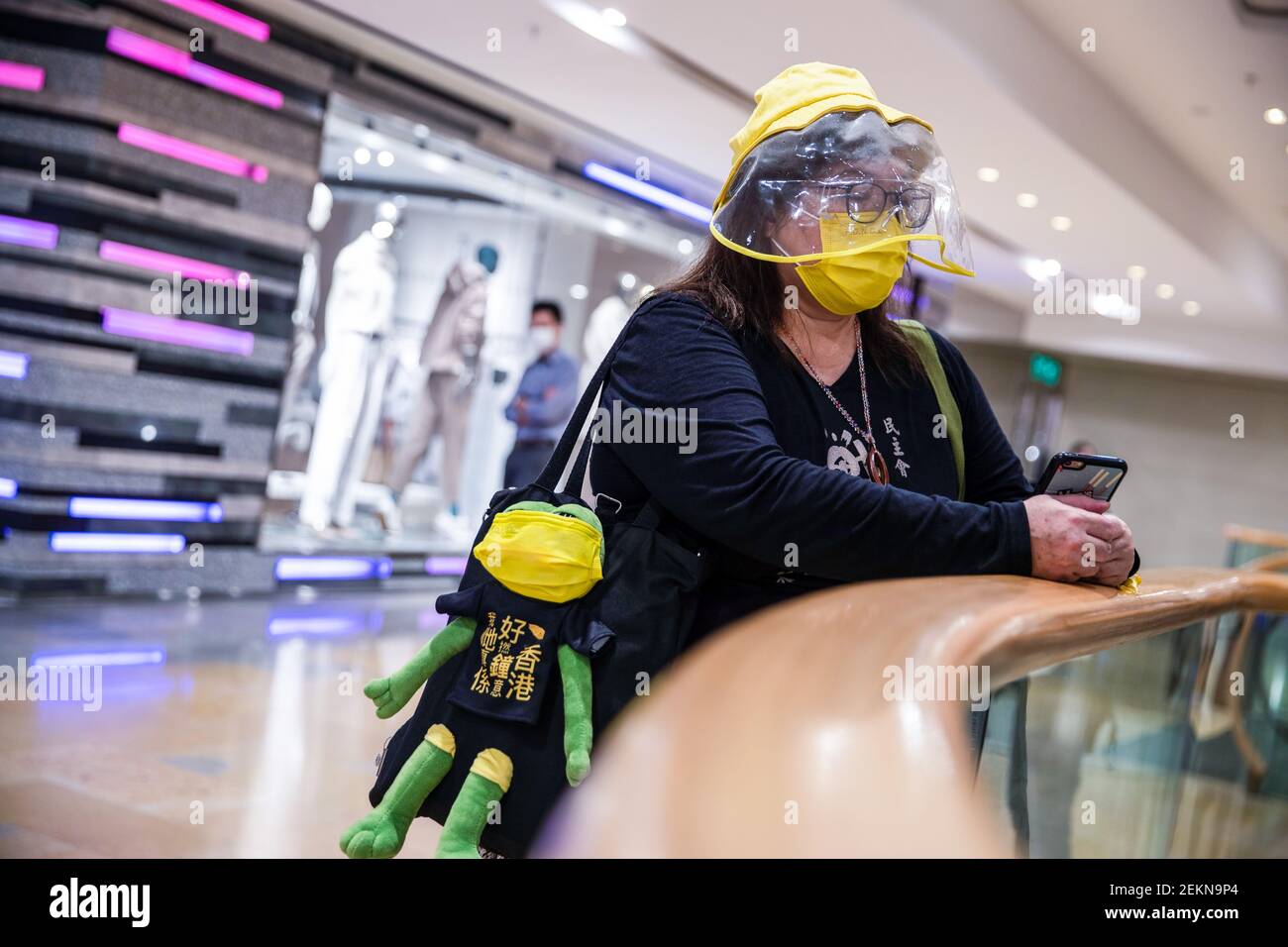 Ein Protestler trägt eine gelbe Maske und einen gelben Hut, während er eine  Protestikon-Tasche "pepe", den Frosch, während des Protestes zum 6th.  Jahrestag der Regenschirm-Bewegung trägt. Dutzende von prodemokratischen  Demonstranten versammelten sich