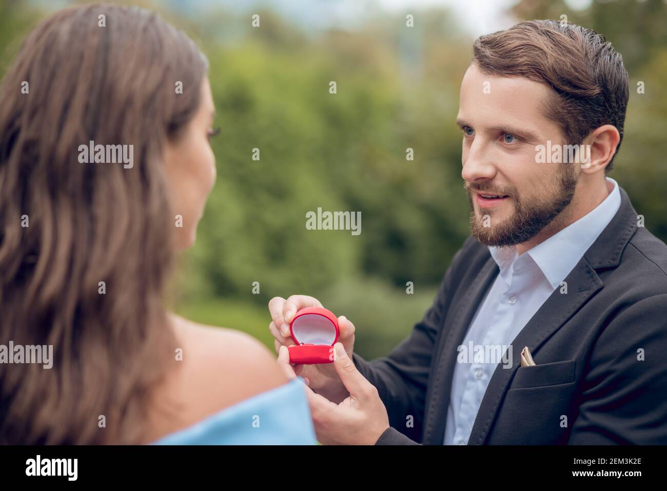 Hoffnungsvoller liebender Mann, der Frau vorschlägt Stockfoto