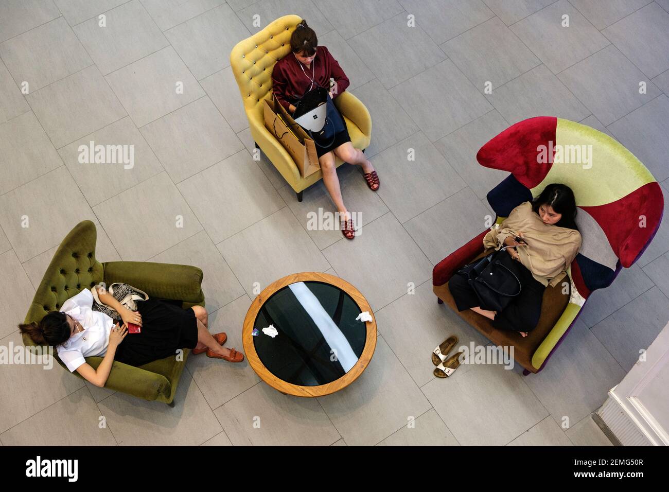 Junge Frauen entspannen im Siam Center Einkaufszentrum in Bangkok, Thailand Stockfoto