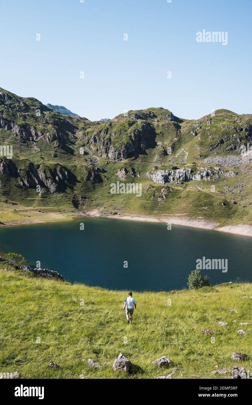 Unbeschwerter Mann auf einer Wiese in der Nähe eines Sees - Lagos de Saliencia - Asturien - Spanien Stockfoto