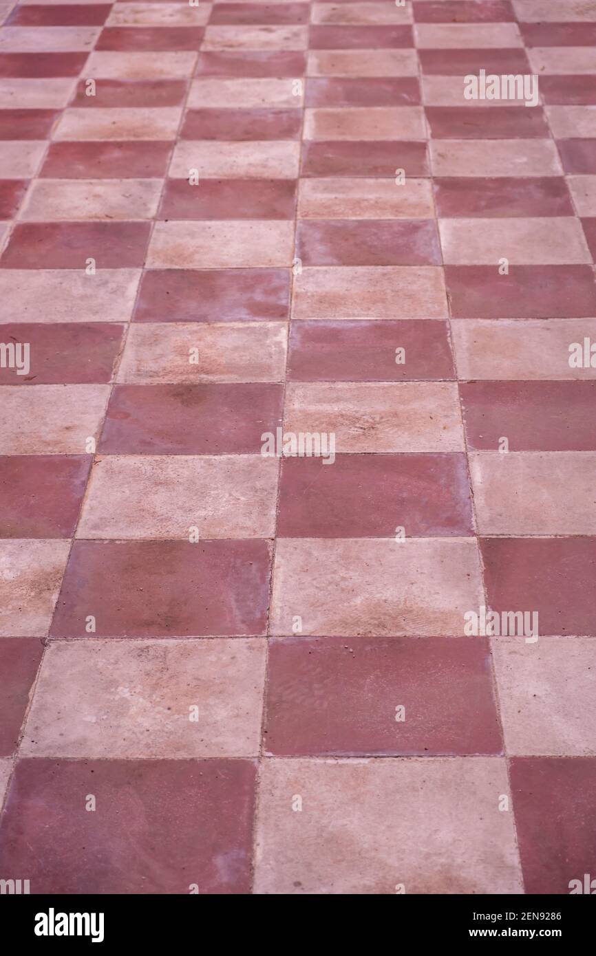 Terracotta Boden alten Fliesen Hintergrund, Textur. Retro, Vintage Fliesenboden, rot, rosa weiß Farbe. Keramikfliesen Schachbrett Stil Boden, perspektiv Stockfoto
