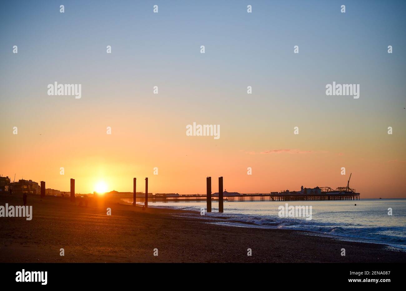 Brighton UK 26th February 2021 - Sonnenaufgang über Brighton Palace Pier heute Morgen, da sonniges Wetter für die nächsten Tage prognostiziert wird : Credit Simon Dack / Alamy Live News Stockfoto