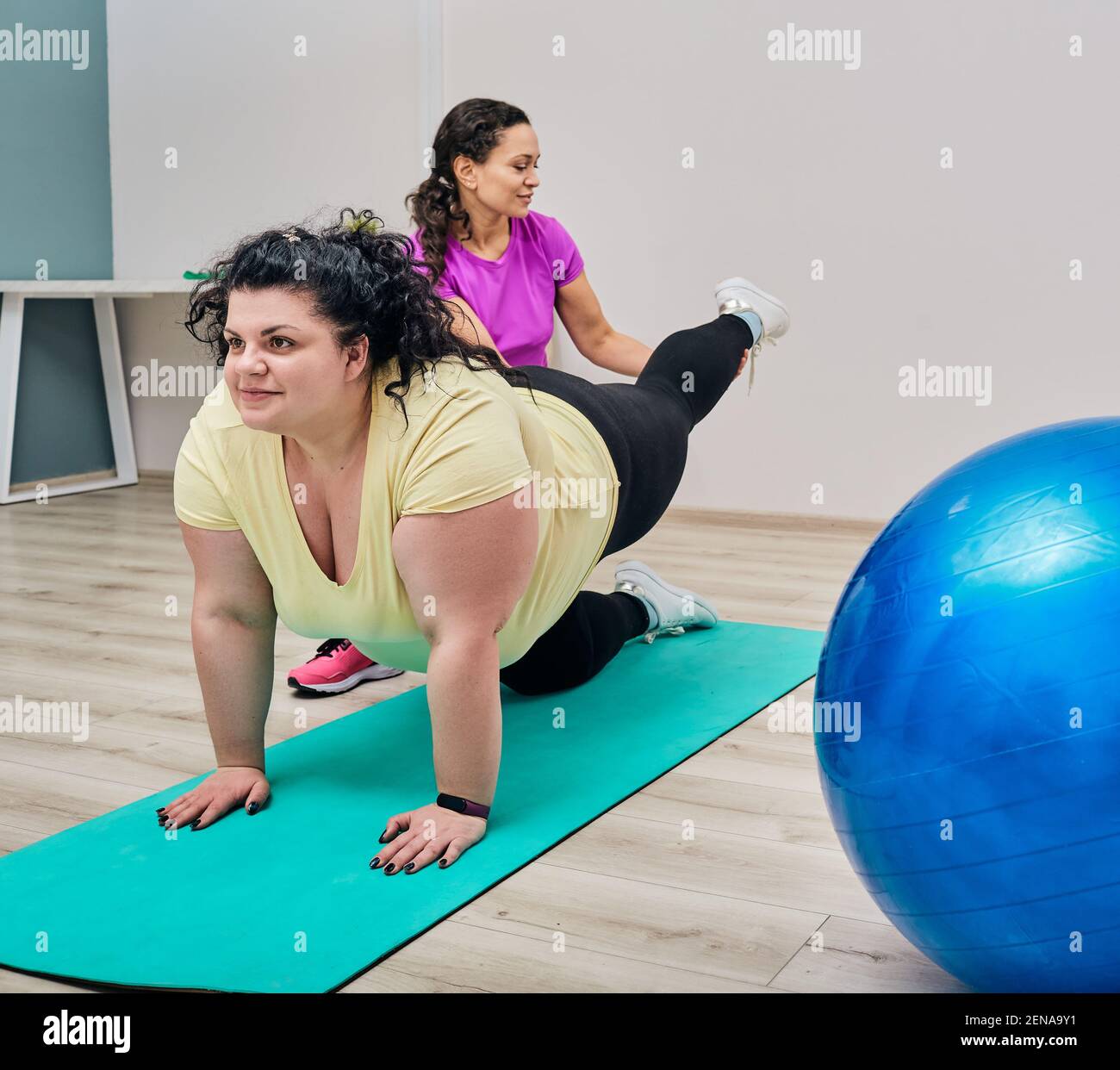 Übergewichtige Frau macht Dehnung und Übungen mit einem Fitness-Trainer Für Gewichtsverlust und Gesundheit Stockfoto