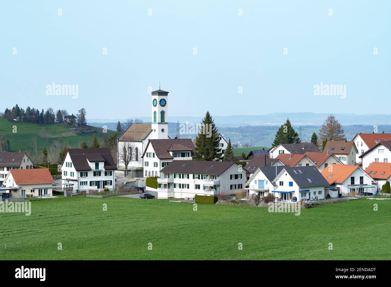 Blick auf das Dorf Schönenberg, Schweiz, mit umliegenden Feldern und Hügeln Stockfoto