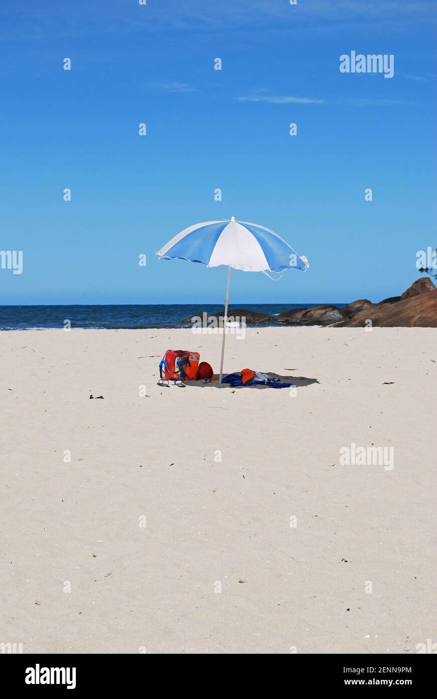 Blauer und weißer Regenschirm am Strand in Brasilien Stockfoto