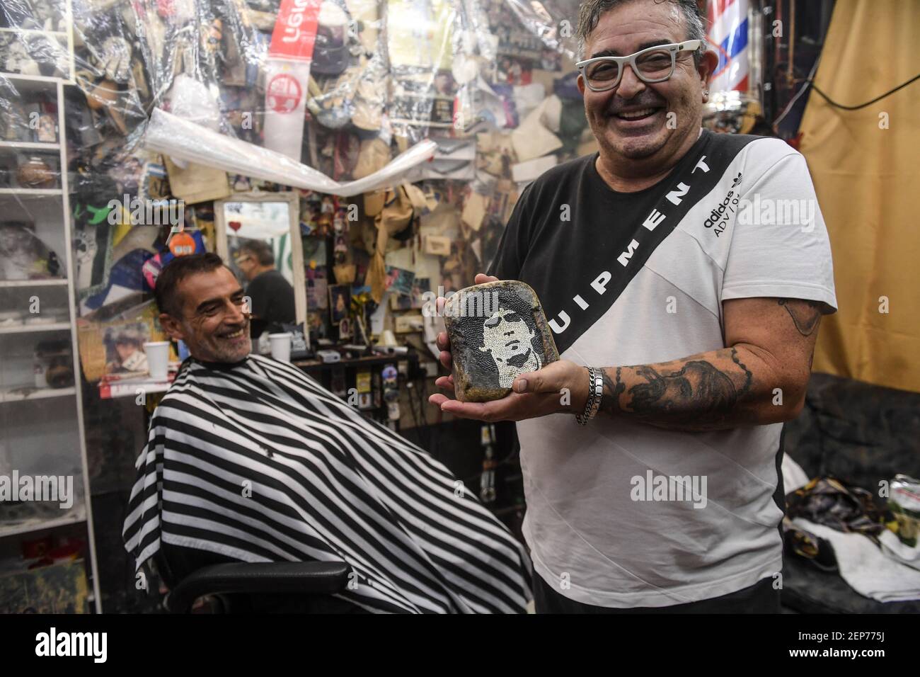 Buenos Aires, Argentinien. Februar 2021, 12th. Julio Pan zeigt in seinem Friseursalon ein Bild des Fußballstars Maradona auf einem Stein. (Zu dpa 'Maradonas Erbe: Zwischen heiligem Verehrung und Schlammschlachten' vom 27,02.2021) Quelle: Fernando Gens/dpa/Alamy Live News Stockfoto