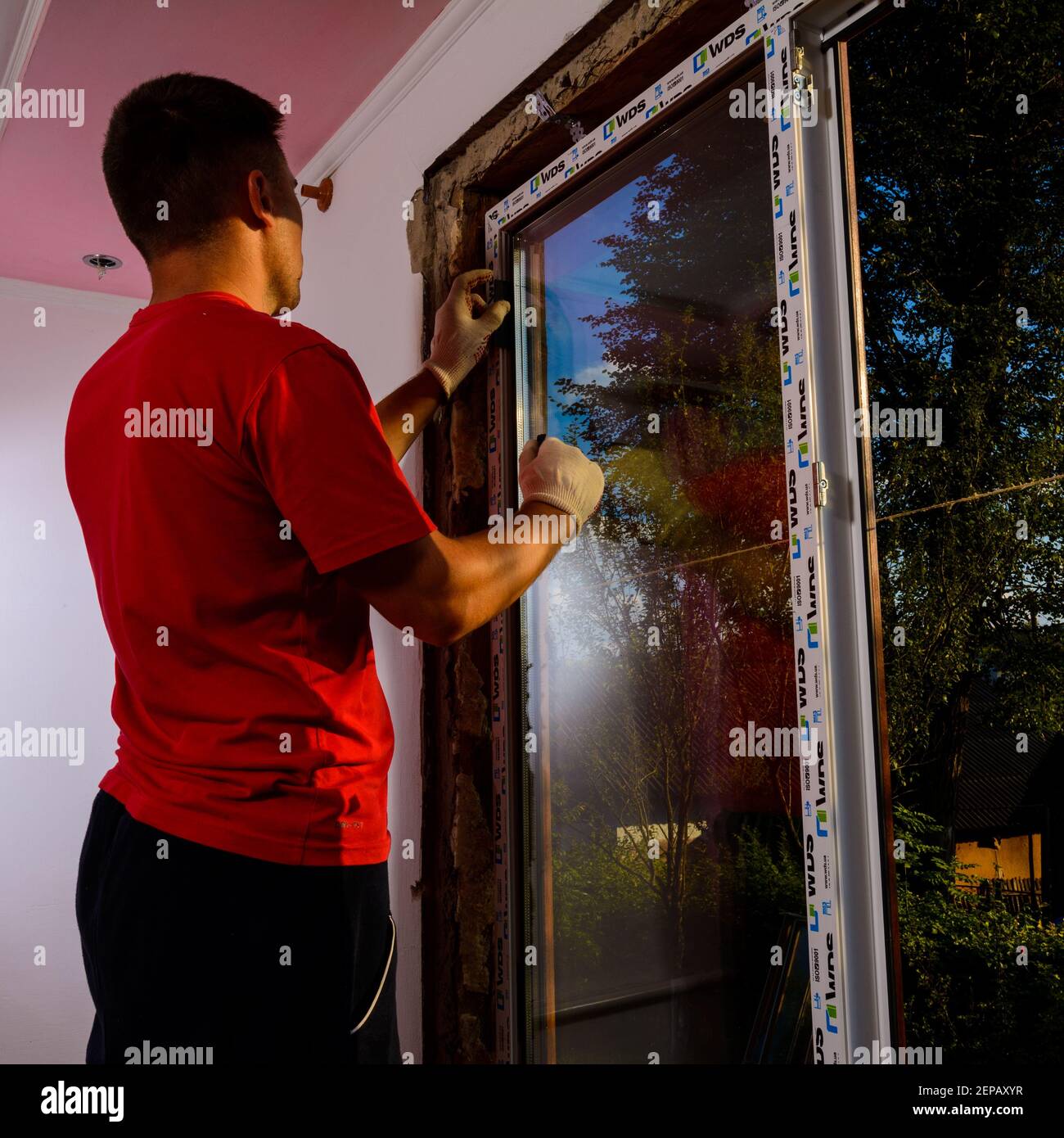 Dolyna, Ukraine 31. Juli 2020: Ein Mitarbeiter installiert ein Fenster im Haus, Installation eines Kunststofffensters, wds-Fenster, energiesparende Fenster. Stockfoto