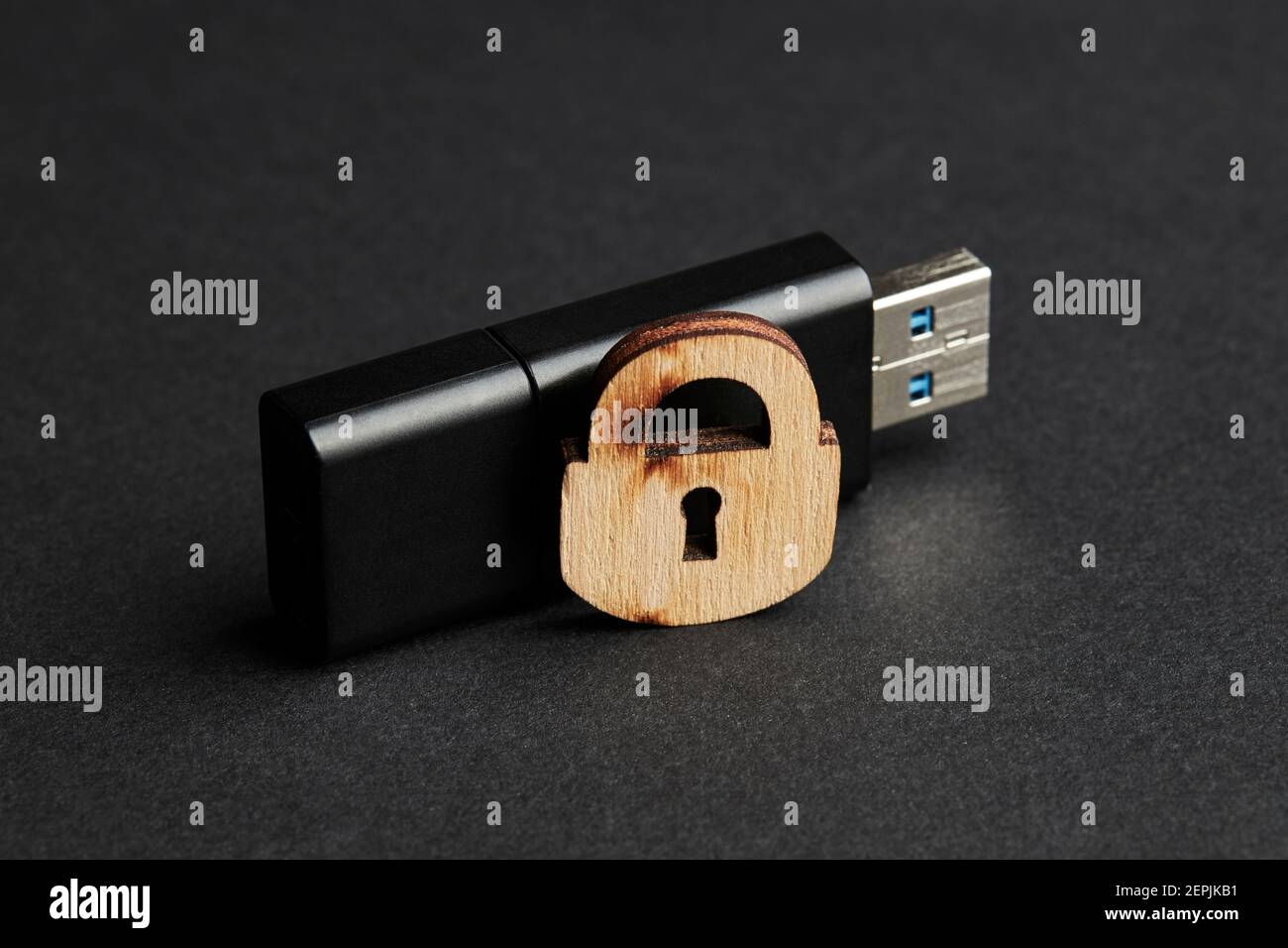 Digitale Sicherheit für elektronische Privatsphäre-Daten-Konzept. Dunkel launisch Foto. Schwarzer usb-Stick mit Holzschloss über mattem Hintergrund Stockfoto