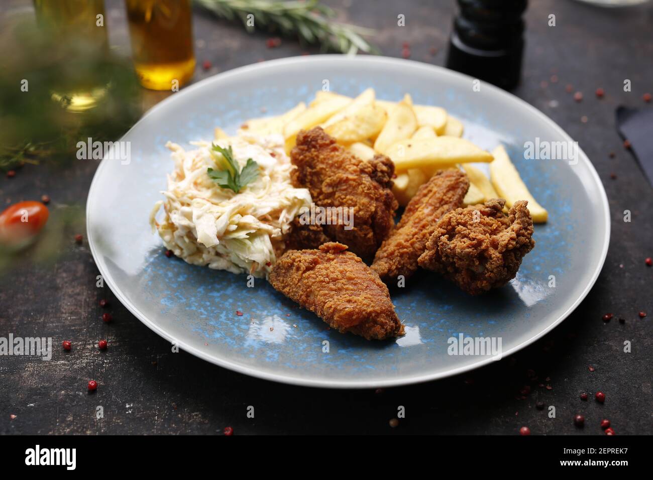 Chicken Nuggets mit Pommes Frites und Krautsalbe. Fast Food Abendessen. Das fertige Gericht auf einem Teller serviert. Serviervorschlag, kulinarische Fotografie. Stockfoto