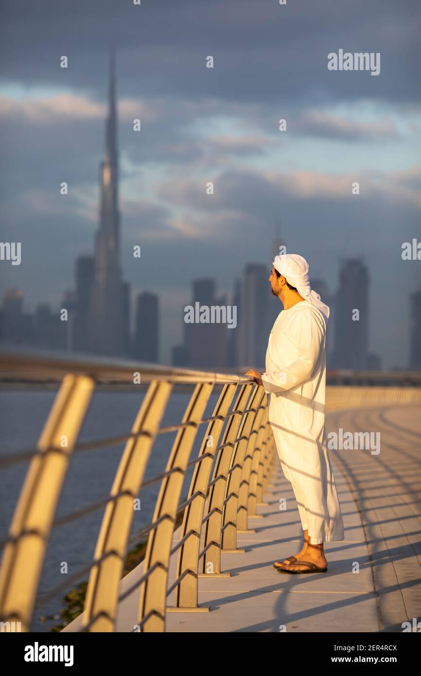 emirati man in Al Jaddaf Waterfront in Dubai mit Burj Khalifa im Hintergrund Stockfoto