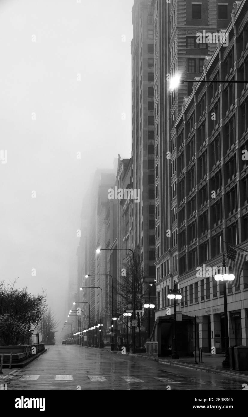 Leere Stadtstraße mit hohen Gebäuden an einem nebligen Morgen Stockfoto