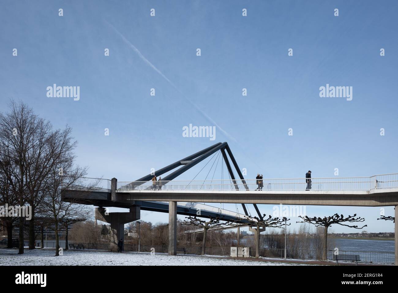 Sonnige Außenansicht der Fussgängerbrücke, Fußgängerbrücke, Rheinpark Bilk und schneebedecktes Feld an der Rheinpromenade in der Wintersaison. Stockfoto
