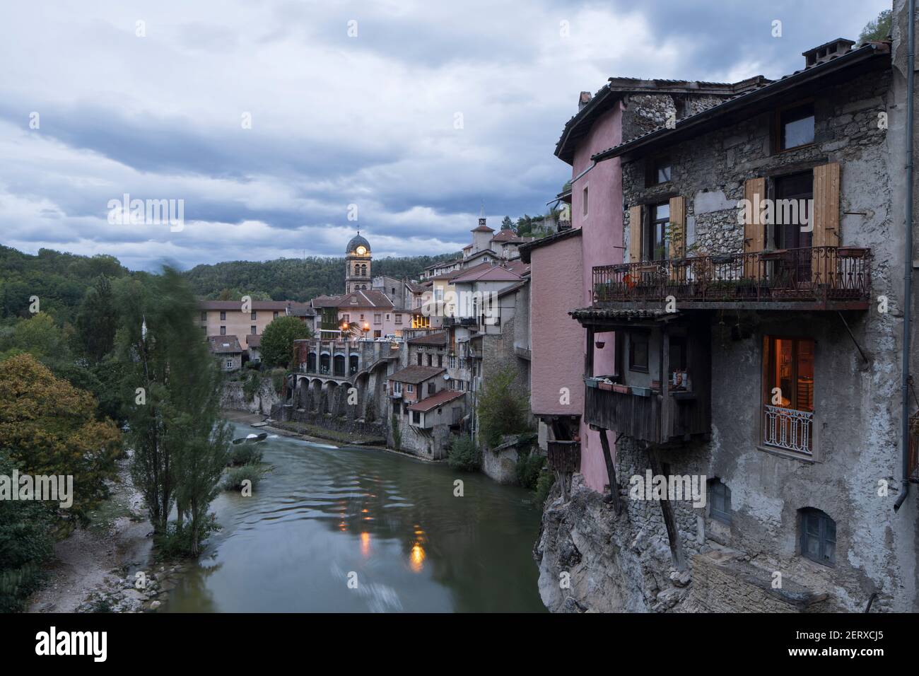 Blick entlang des Flusses einer der charakteristischen Hängewohnungen von Pont-en-Royans, in der Region Auvergne-Rhone-Alpen, während der Dämmerung Stockfoto