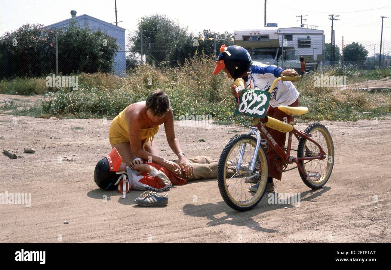 BMX-Fahrer wird nach einem Unfall bei einem Rennen geholfen Track California USA 1980 Stockfoto