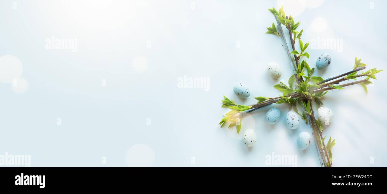 Art Happy Easter Weihnachtsbanner oder Grußkarte Hintergrund mit Osterblumenkreuz und Ostereiern auf blauem Hintergrund; christliches Erwachen Leben symb Stockfoto