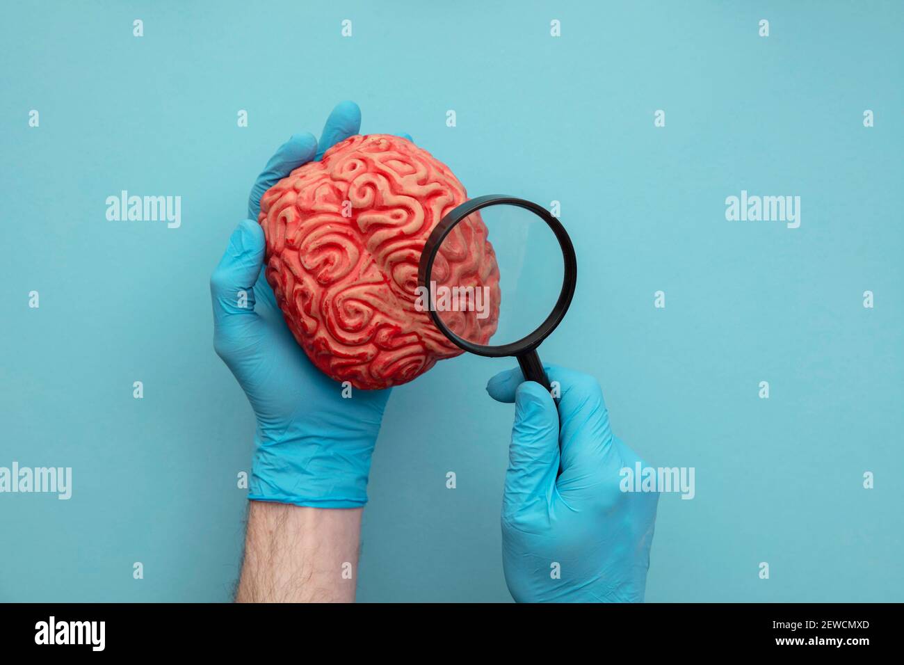 Arzt mit einer Lupe auf ein Gehirn zu sehen. Konzept der psychischen Gesundheit Stockfoto
