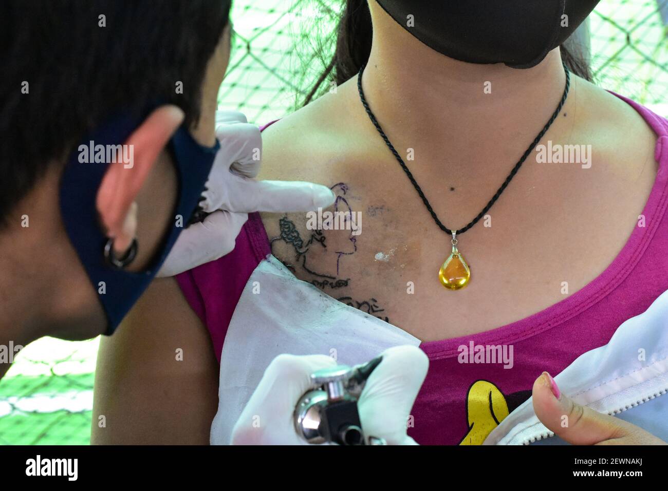 Myanmar, Nyaung Shwe,02 March 2021, : EIN Tattoo-Künstler arbeitet an einem Porträt von Aung San Suu Kyi, gestürzter Regierungschef von Myanmar. In Myanmar bekommen Anhänger der gestürzten Regierungschef Aung San Suu Kyi ihr Gesicht tätowiert. Ob auf der Brust oder am Arm - in dem Land mit mehr als 53 Millionen Einwohnern tragen heute viele das Profil des 75-Jährigen auf der Haut. Hintergrund der Aktion ist nicht nur Bewunderung für den Friedensnobelpreisträger, sondern auch Solidarität: An manchen Stellen gehen die Erlöse aus den Tätowierungen an die Civil Unobedience Movement (CDM), die geführt wird Stockfoto