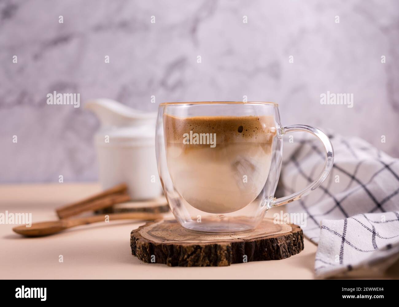 Dalgona Kaffee. Schlagsahne Sahnetrink mit Instant-Kaffee beliebt in Korea cremigen Cocktail in einem transparenten doppelwandigen Glas Becher Stockfoto