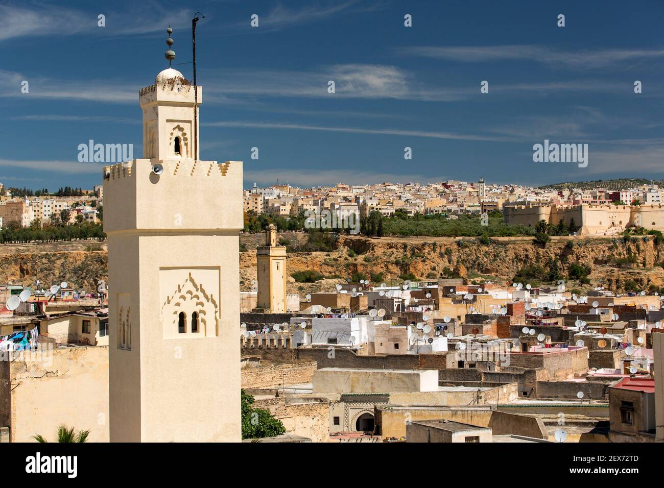 Blick von der Dachterrasse auf die Stadt Fez, mit einem Minarett im Vordergrund. Stockfoto