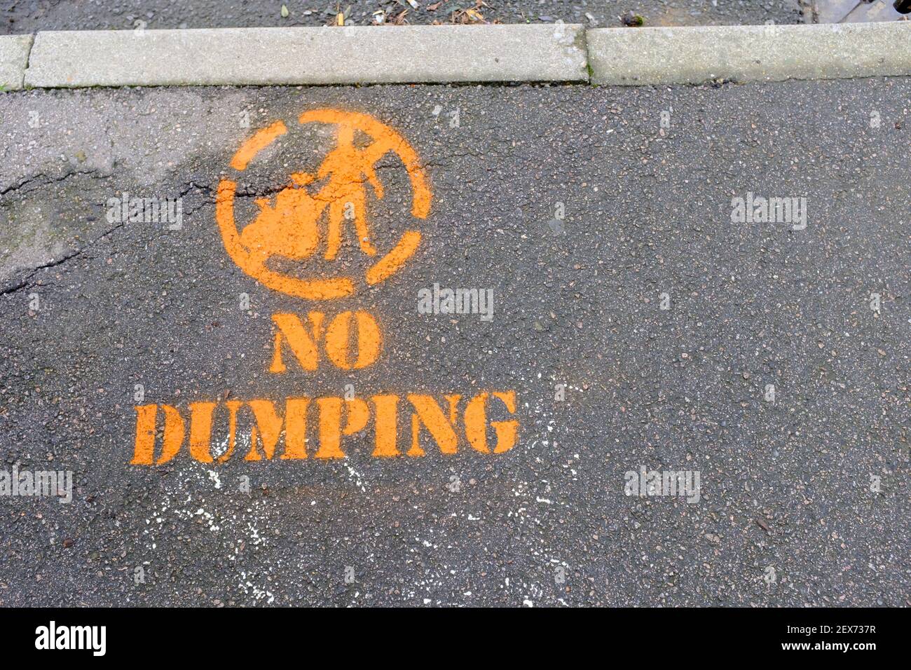 Ein No Dumping Schild Spray auf dem Bürgersteig in Forest Gate, East London gemalt. Stockfoto