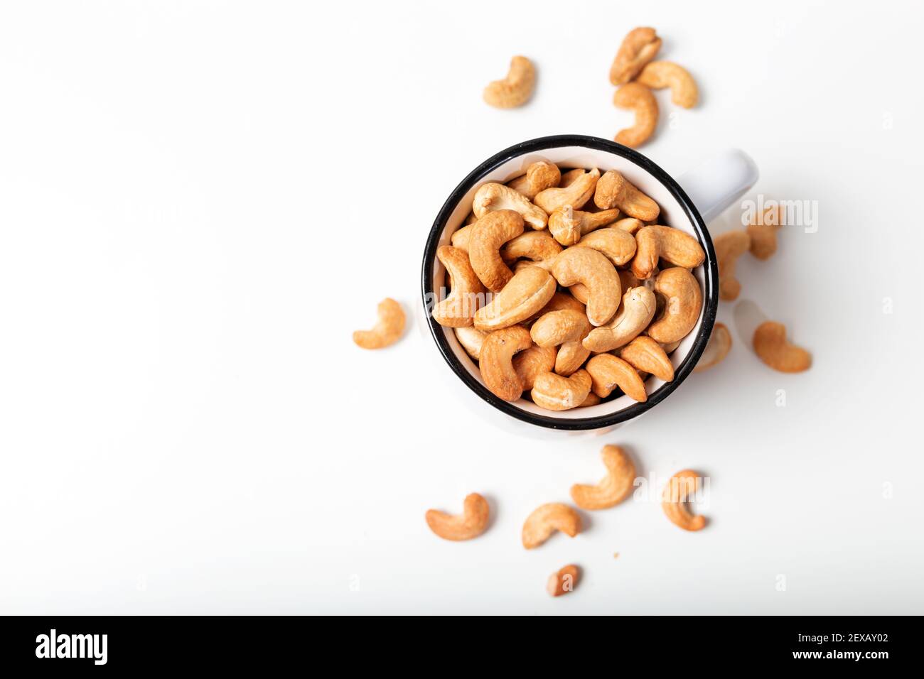 Cashew Frucht in der weißen Tasse auf weißem Hintergrund. Draufsicht. Stockfoto