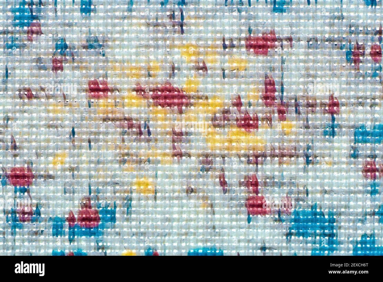 Makroaufnahme aus feinem weißen Stoff mit leuchtend gelben, blauen und roten Blobs Stockfoto