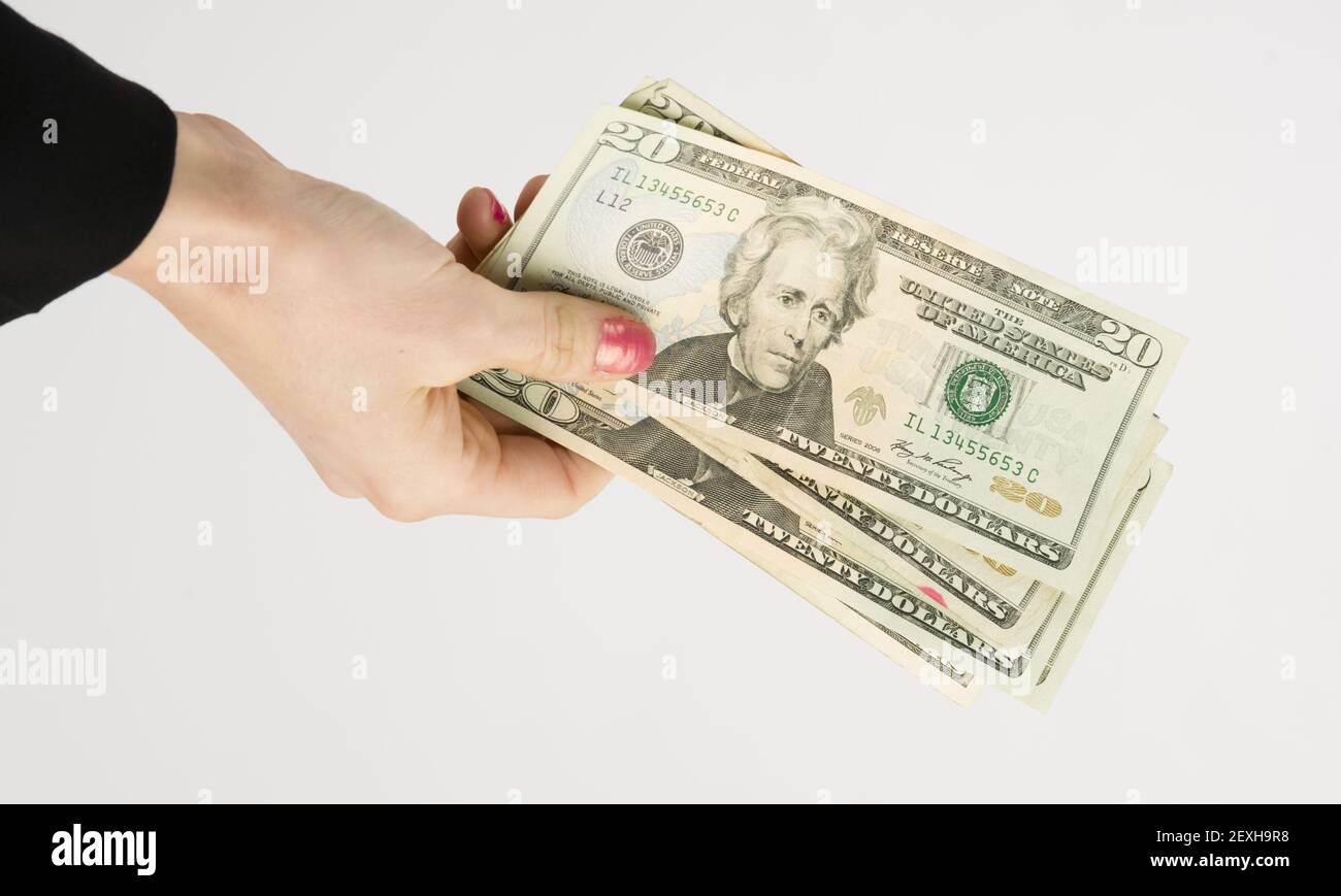 Weibliche Hand hält Zahlung Währung zwanzig Dollar Bargeld Rücken grün Stockfoto