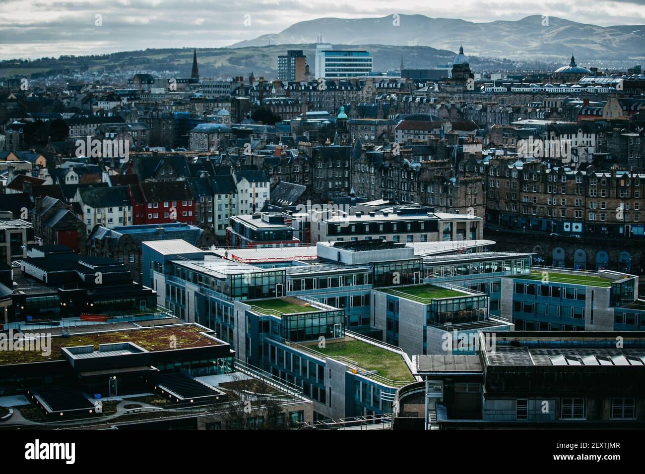 Das Dach der Stadtverwaltung von Edinburgh, Waverley Court, das mit Solarzellen ausgestattet wurde, mit Blick auf die Stadt Edinburgh im Hintergrund. Stockfoto