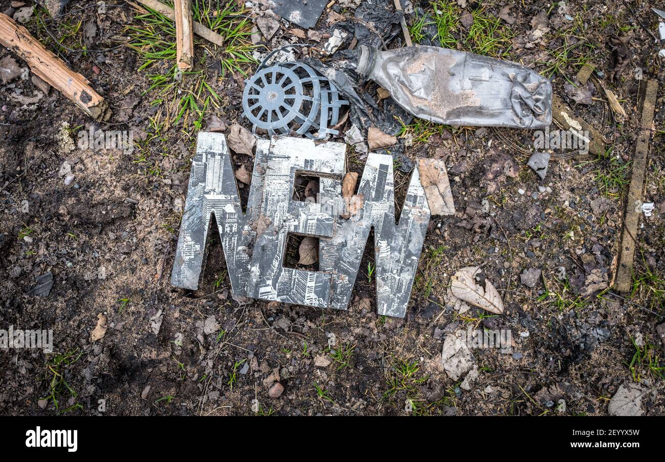 NEUE, 3D Zeichen und andere Kunststoffabfälle auf dem Land deponiert. Stockfoto