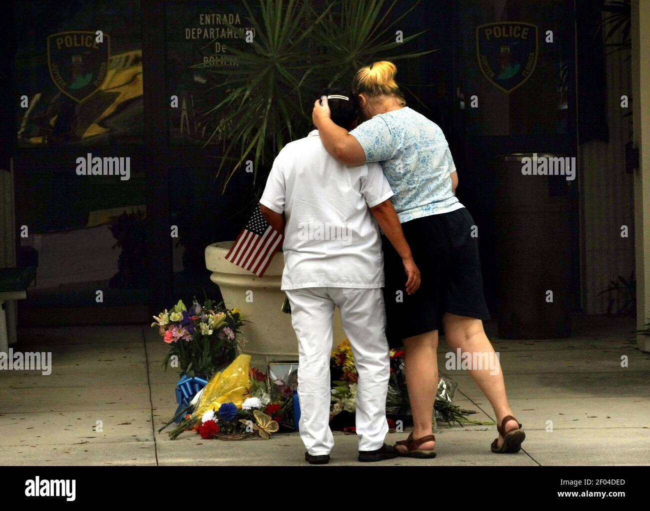 Erin Hitchens tröstet ihre Freundin Ana Flores, während sie am Montag  Nachmittag des 10. September 2012 ein Make-Shift-Denkmal für den  Motorradfahrer Bruce St. Laurent im Jupiter, Florida Police Department  besucht. Offizier St.